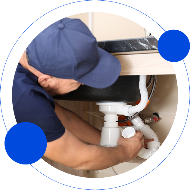 Plumber Wearing a Cap While Fixing the Shink — Appliance Services Repair in Singapore